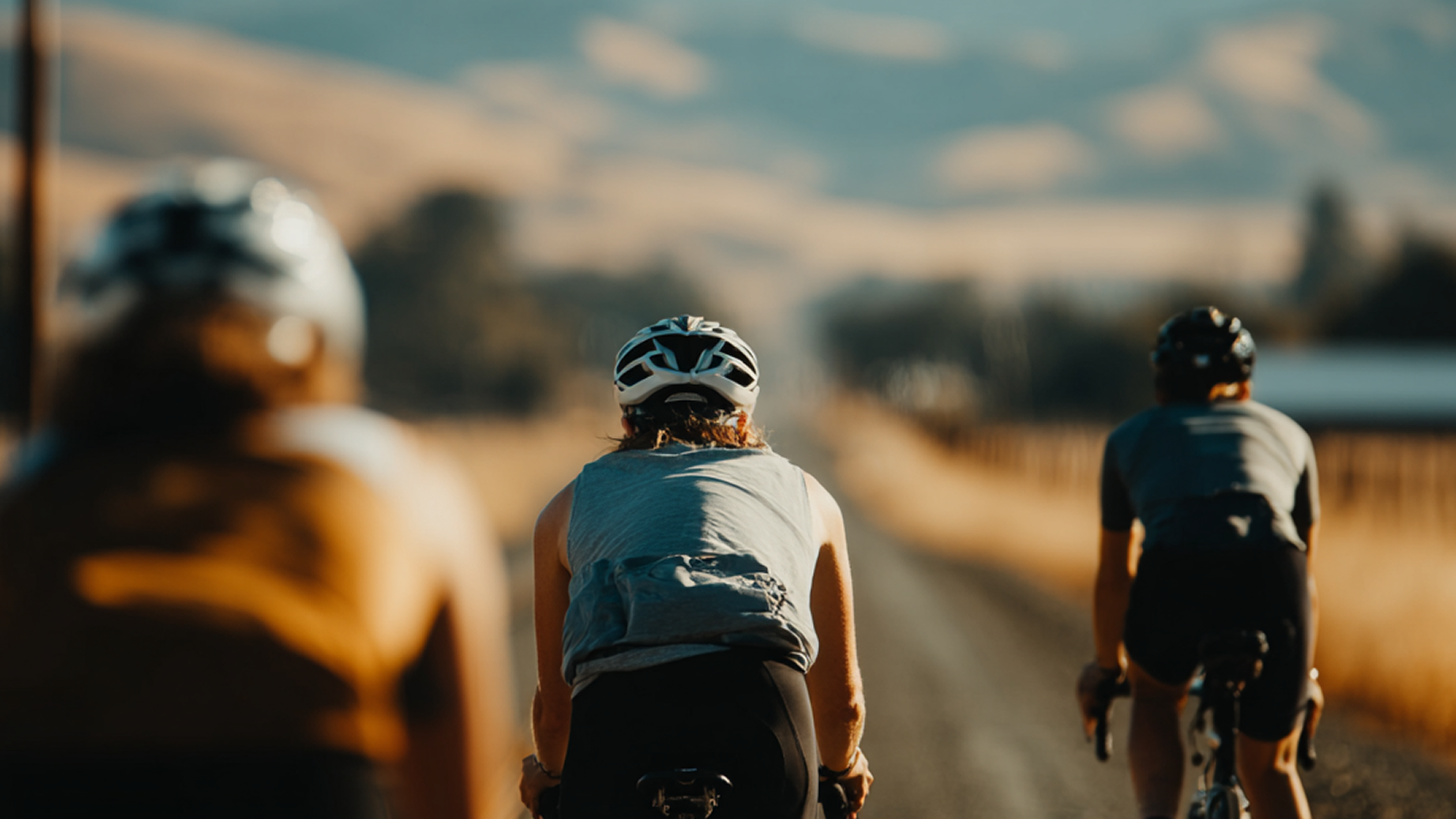 Two people cycling on a mountain trail, representing peak physical performance and active lifestyle.