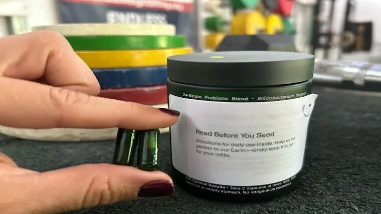 Two Seed DS-01 synbiotic capsules placed side by side on a neutral background.