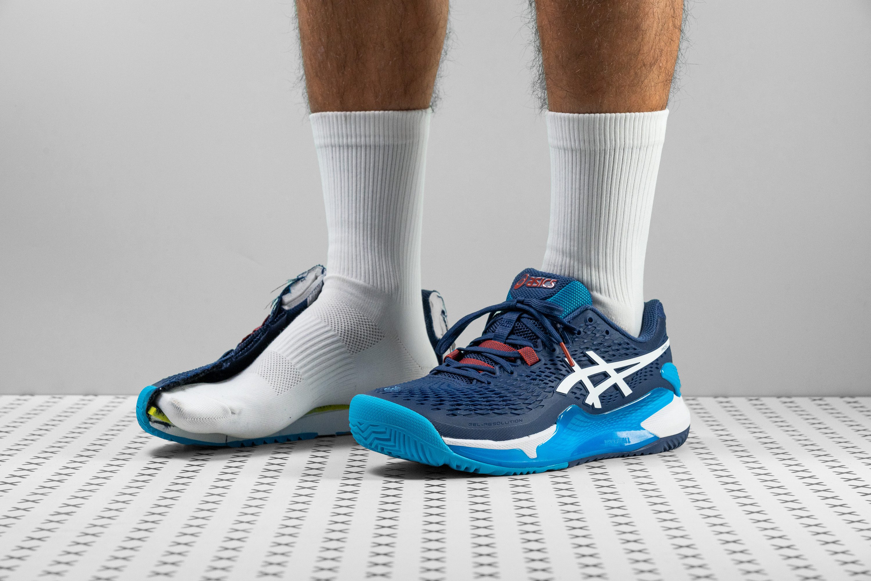 Side profile of the ASICS Gel Resolution 9 tennis shoe.