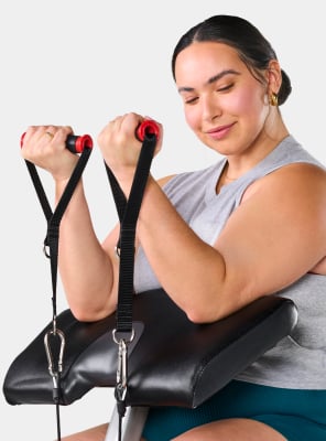 Close-up of the preacher curl attachment on the Bowflex Revolution machine.