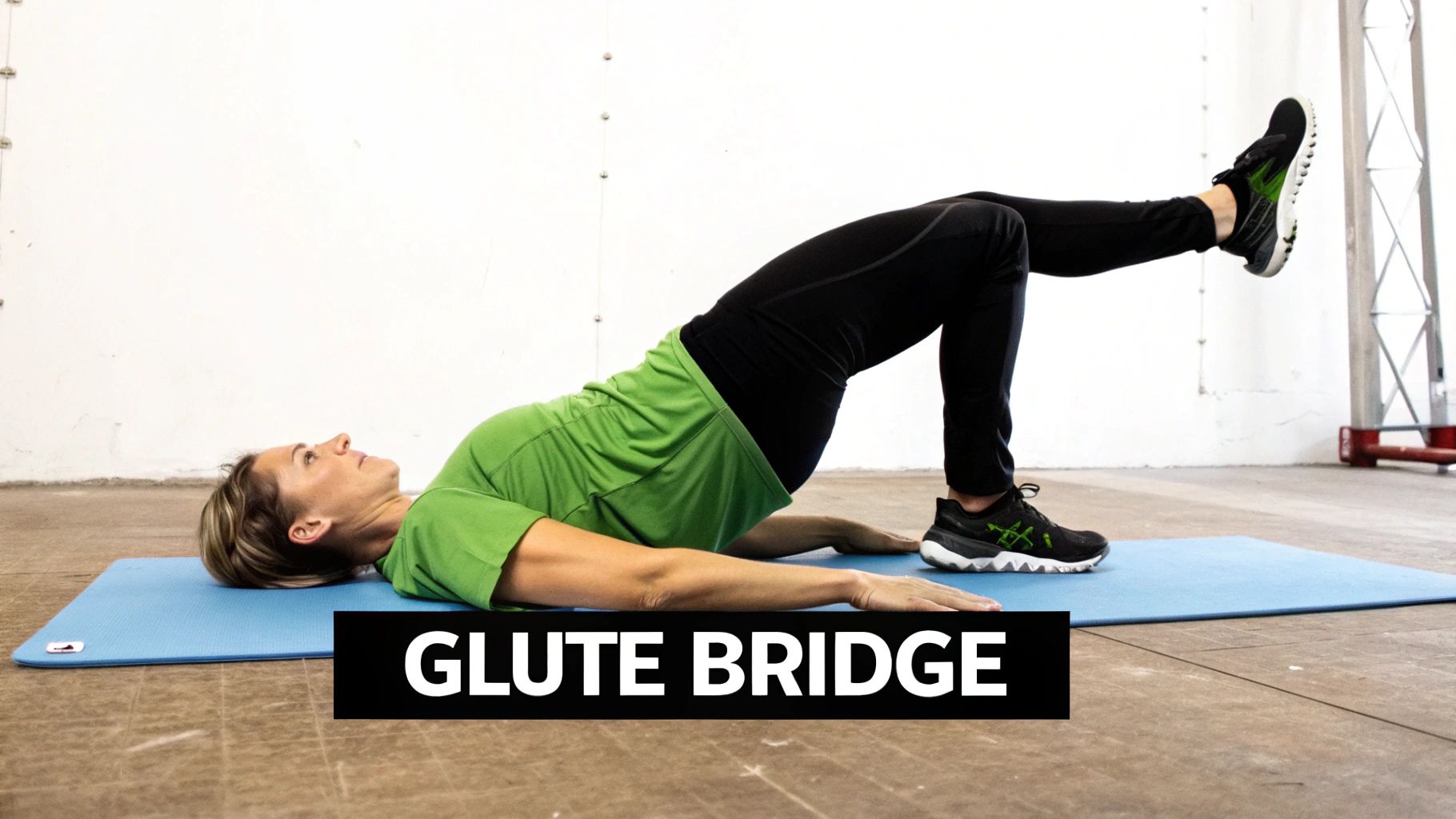 A woman performing a single-leg glute bridge to strengthen the pelvic and lower back muscles.