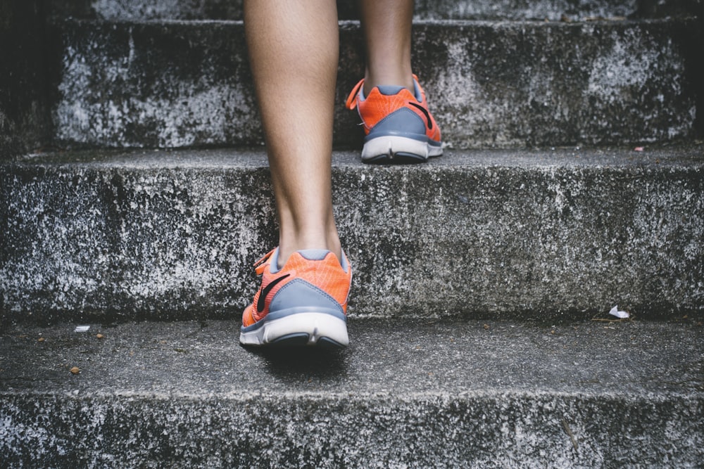A person walking with a steady pace on a paved nature trail.