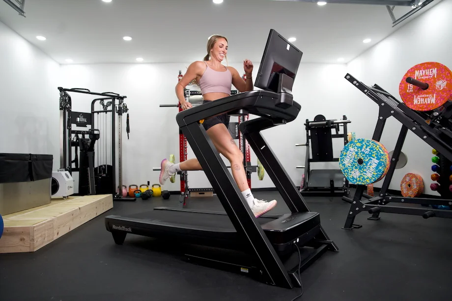 An expert reviewer walking on a NordicTrack treadmill to test its performance.