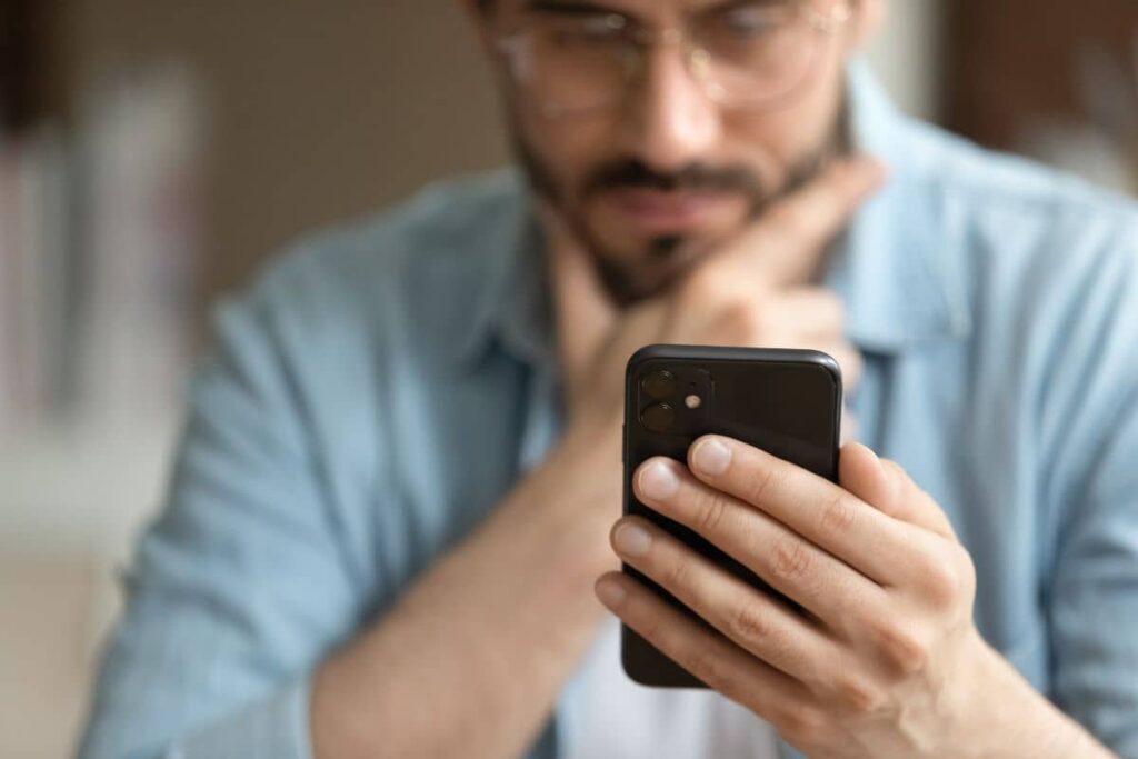 A person using a smartphone to research medication costs and financial assistance programs.