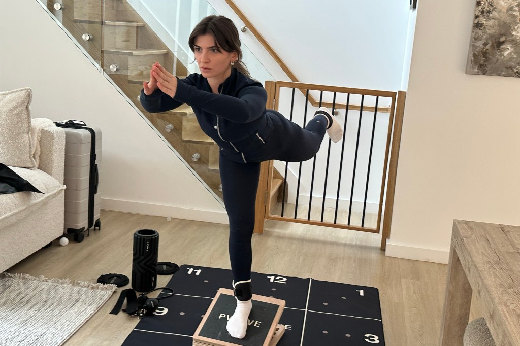 A person using the Pvolve Slant Board for balance training and lower body sculpting.