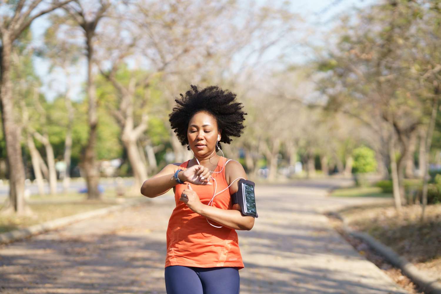 A woman running outdoors maintaining a moderate-to-vigorous intensity pace.