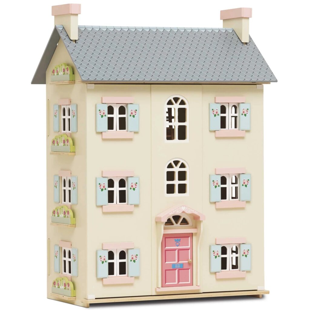 Classic three-story white wooden doll house with a blue roof.