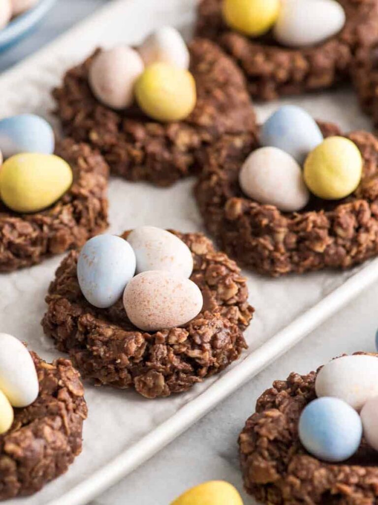Toasted coconut nest cookies shaped like bird nests with small egg-shaped candies inside. (SEO: healthy Easter nest cookies).