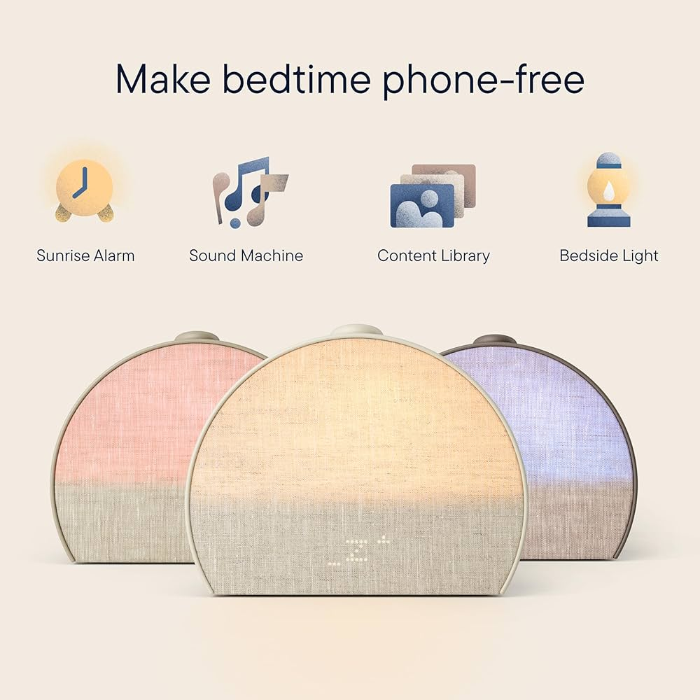 A Hatch Restore smart sleep device on a wooden nightstand.