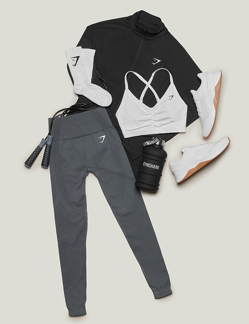 A rose pink workout set layered with a matching long-sleeve top for transition wear.