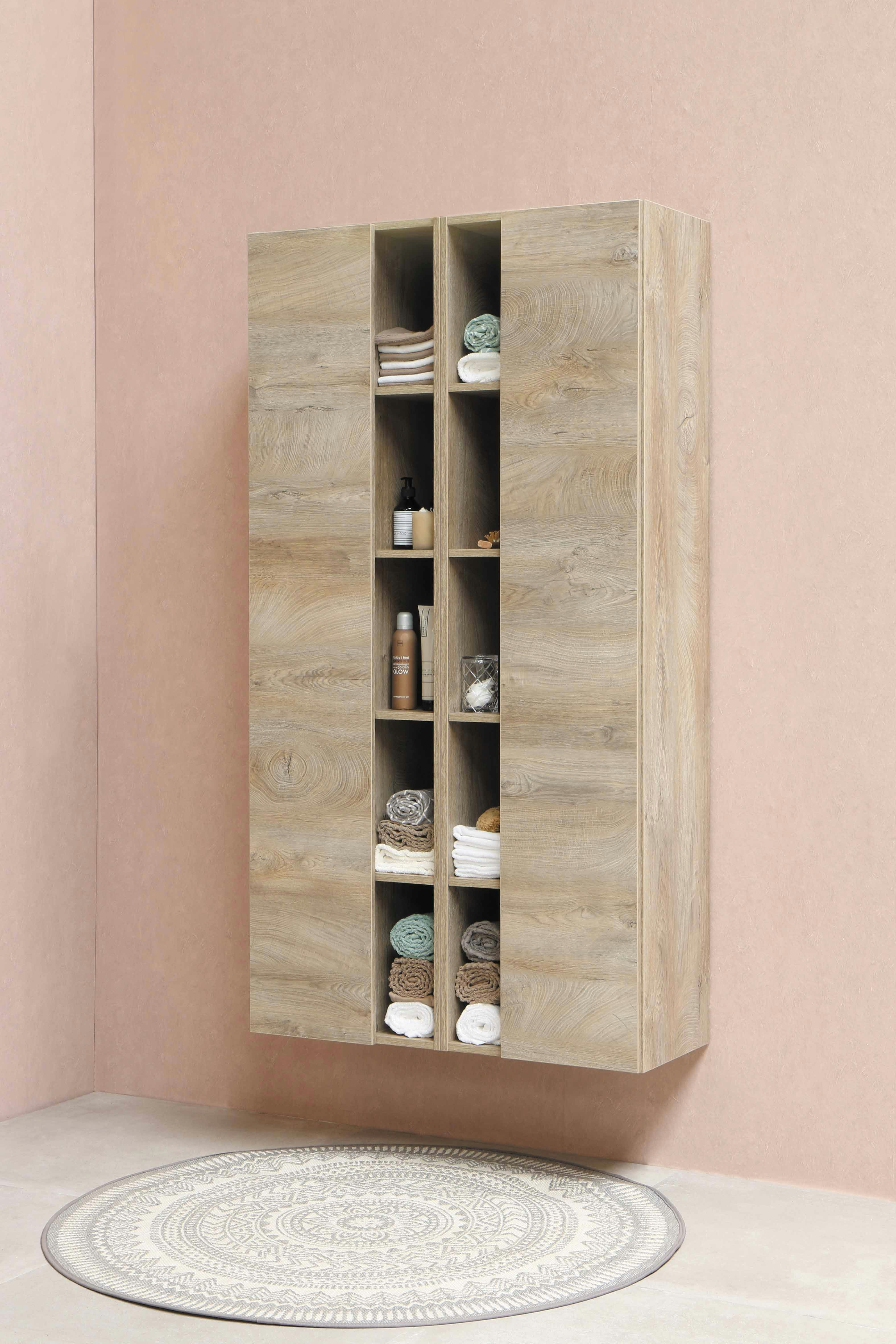 An impeccably organized closet with neutral-toned clothing neatly arranged on wooden hangers.