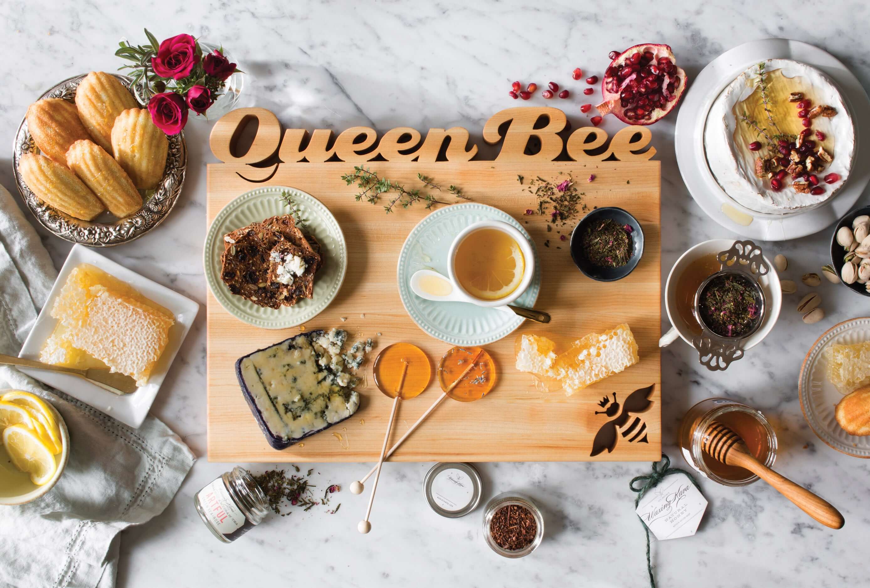 A full, personalized charcuterie board featuring a variety of textures and small containers.