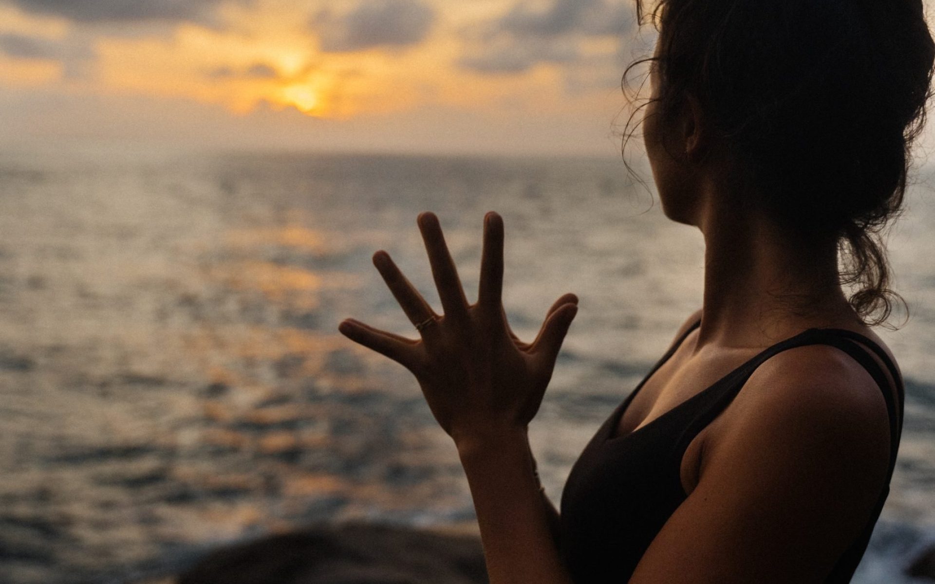 A yoga practitioner in a classic pose during an early morning outdoor session.