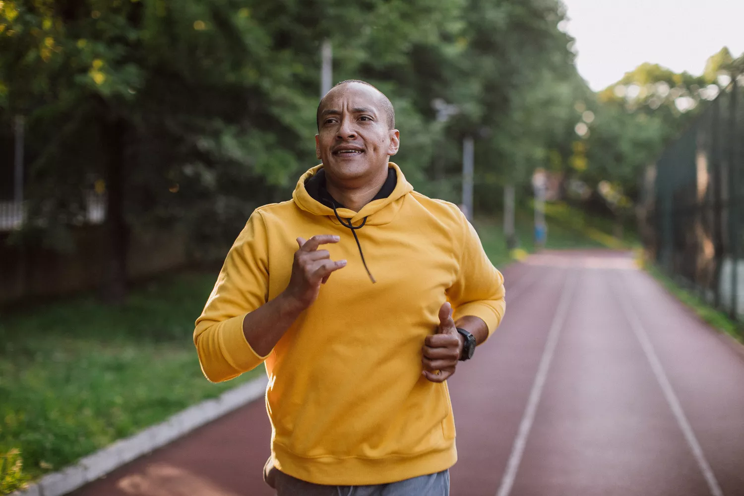 An athlete running on a professional outdoor track.