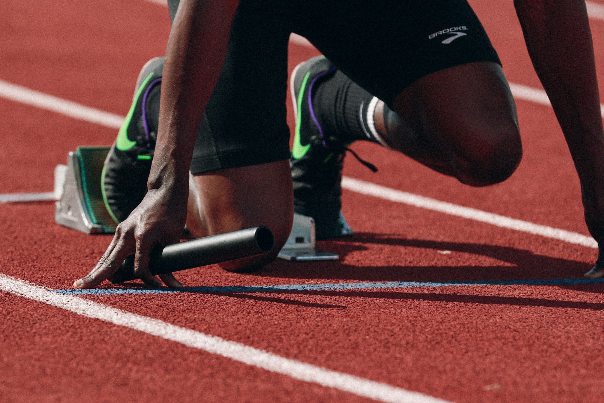 An athlete in mid-sprint showcasing muscular power and explosive acceleration.