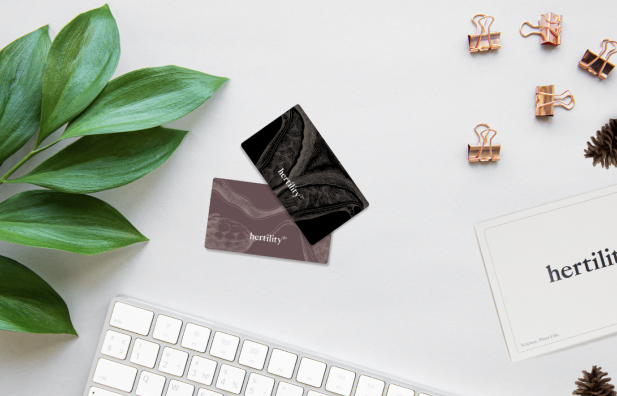 A woman holding a gift card with text suggesting it is the gift every woman wants.