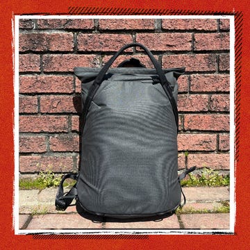 Open roll-top gym backpack showing internal compartments and organized gear.