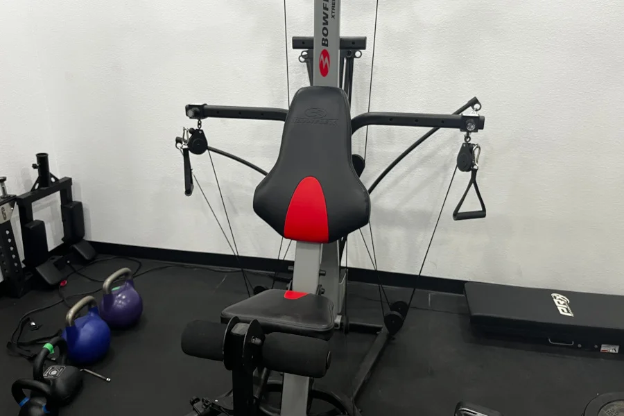 A Bowflex Xtreme 2 SE Home Gym set up in a garage.