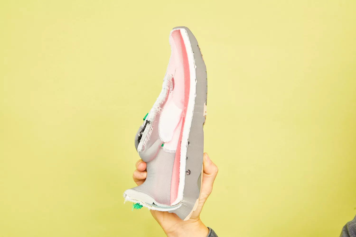 A cross-section of a running shoe showing the layered construction of the foam midsole and cushioning units.