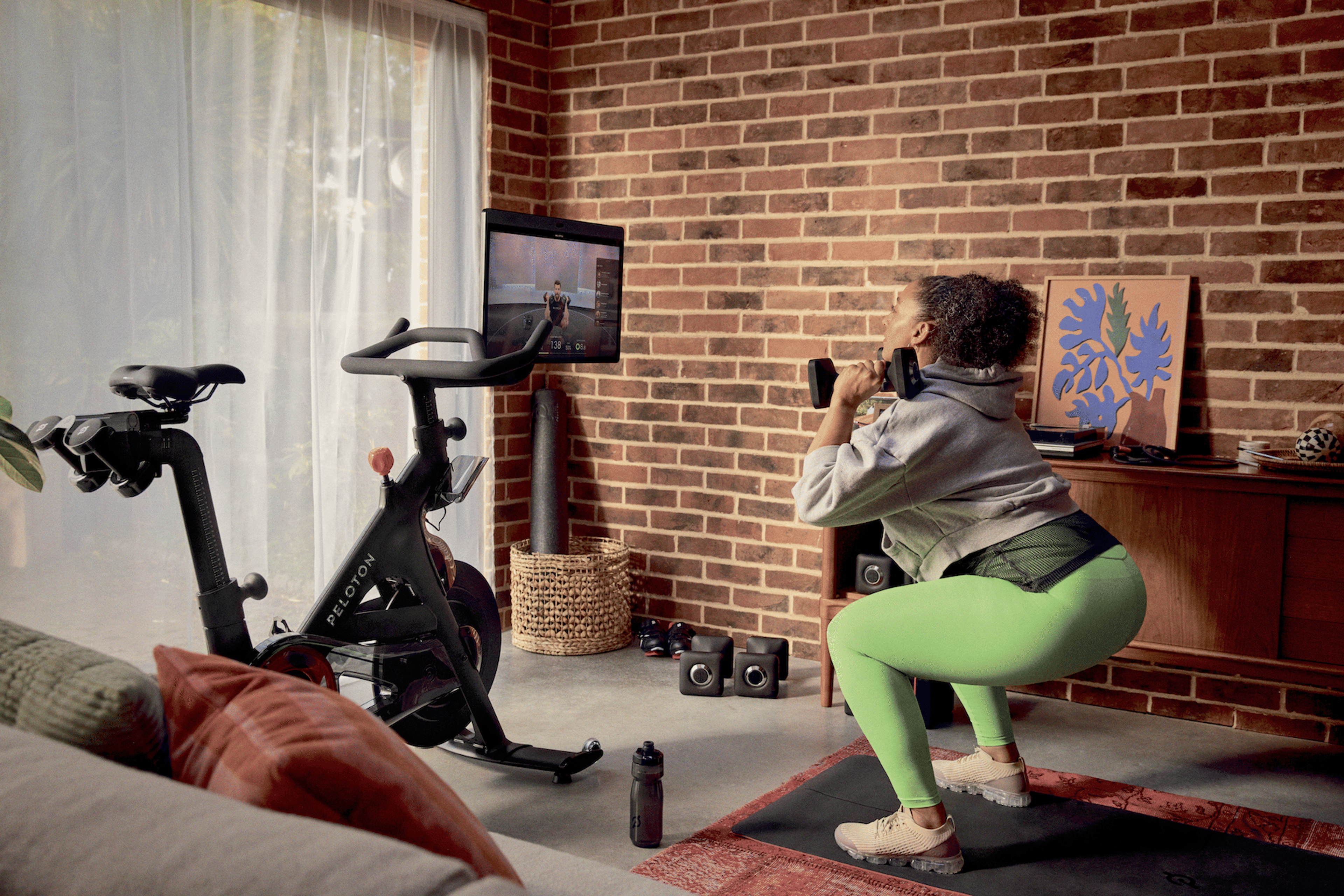 A person performing deep squats with dumbbells to demonstrate improved hip and ankle mobility.