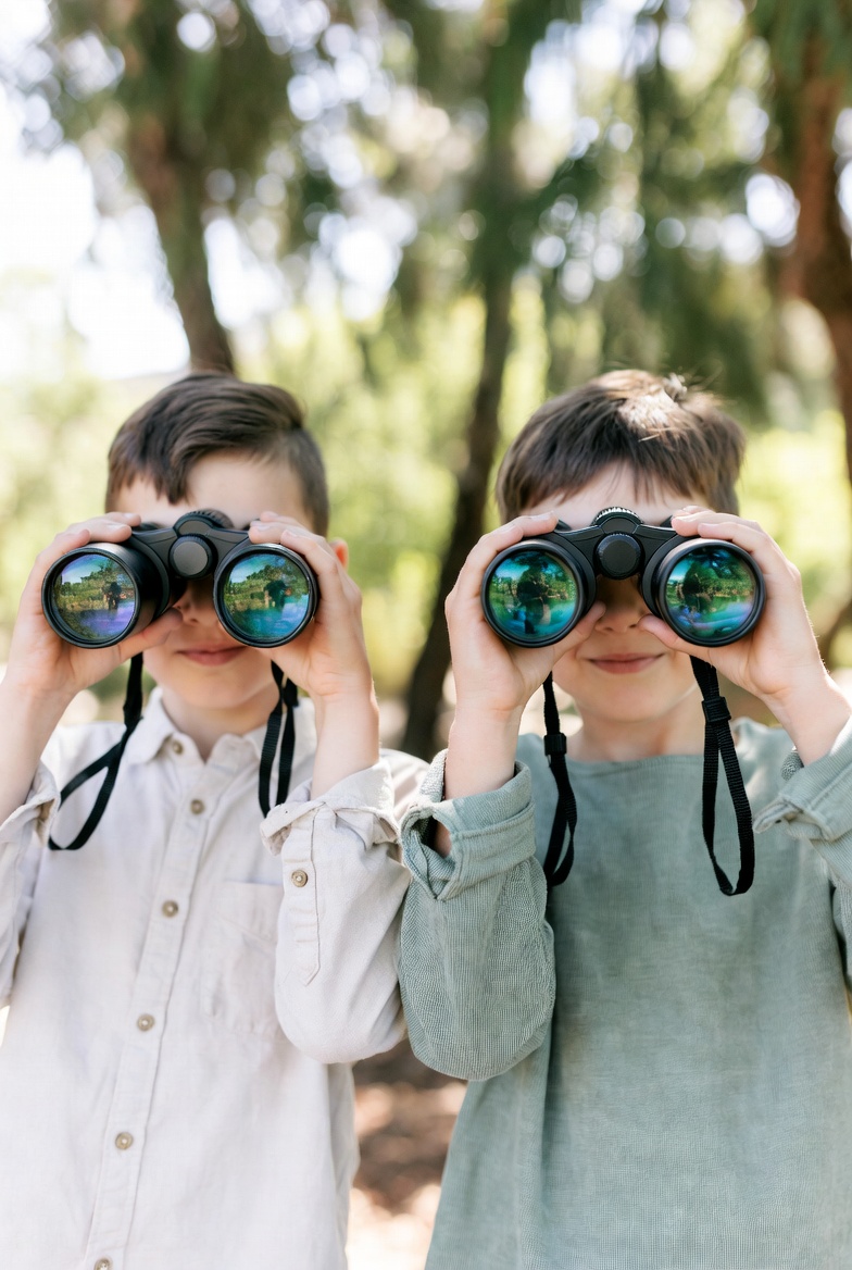 Yellow shockproof binoculars designed for children's outdoor exploration.
