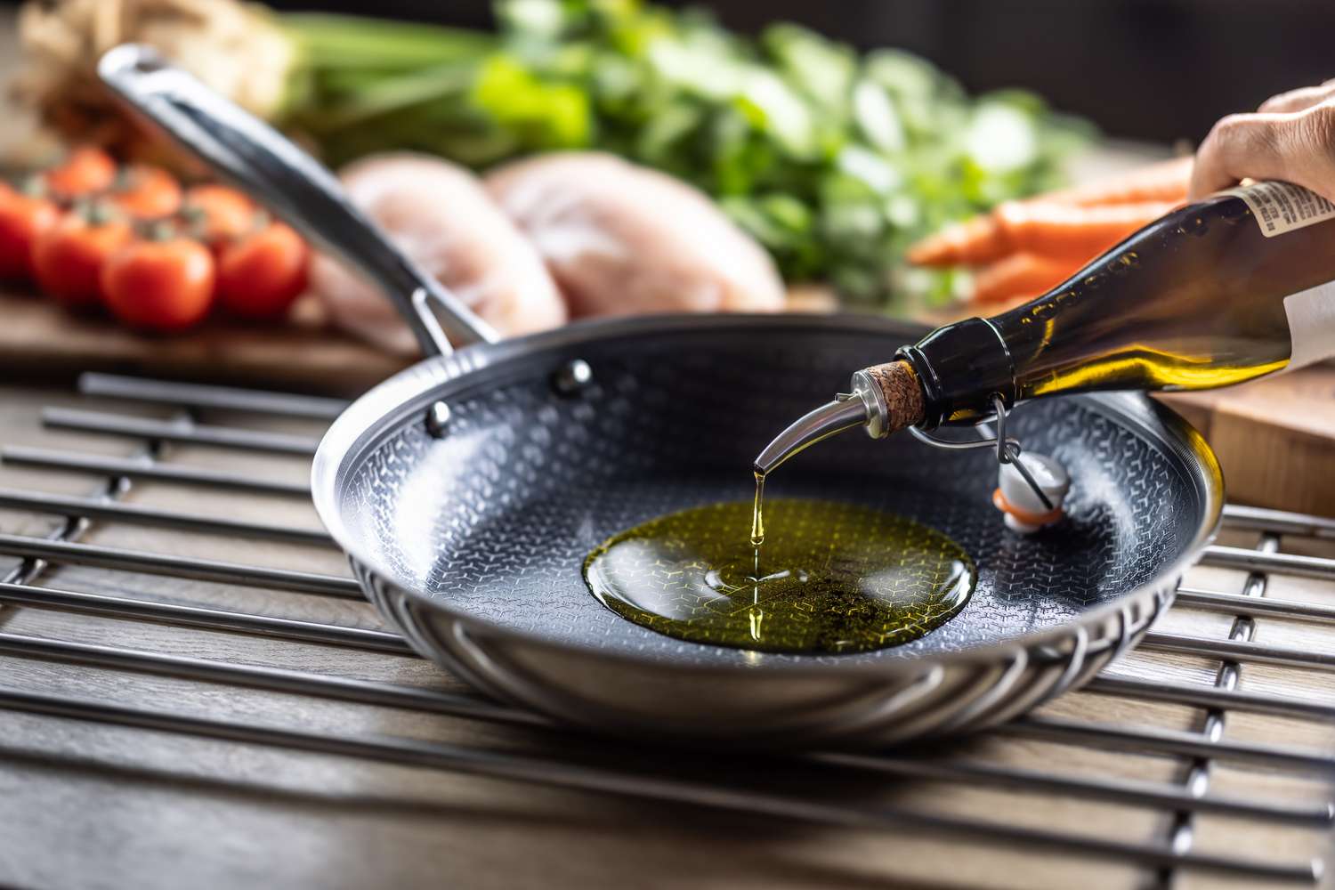 Golden olive oil being poured into a cooking pan.