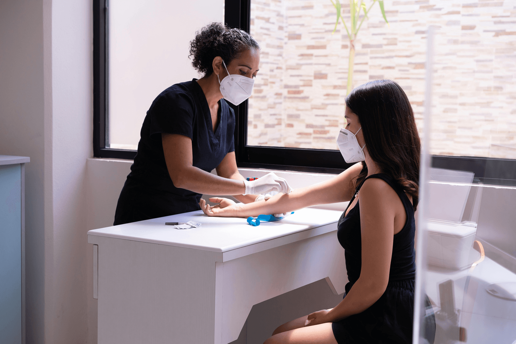 A person using a finger-prick blood collection kit for an at-home hormone test.