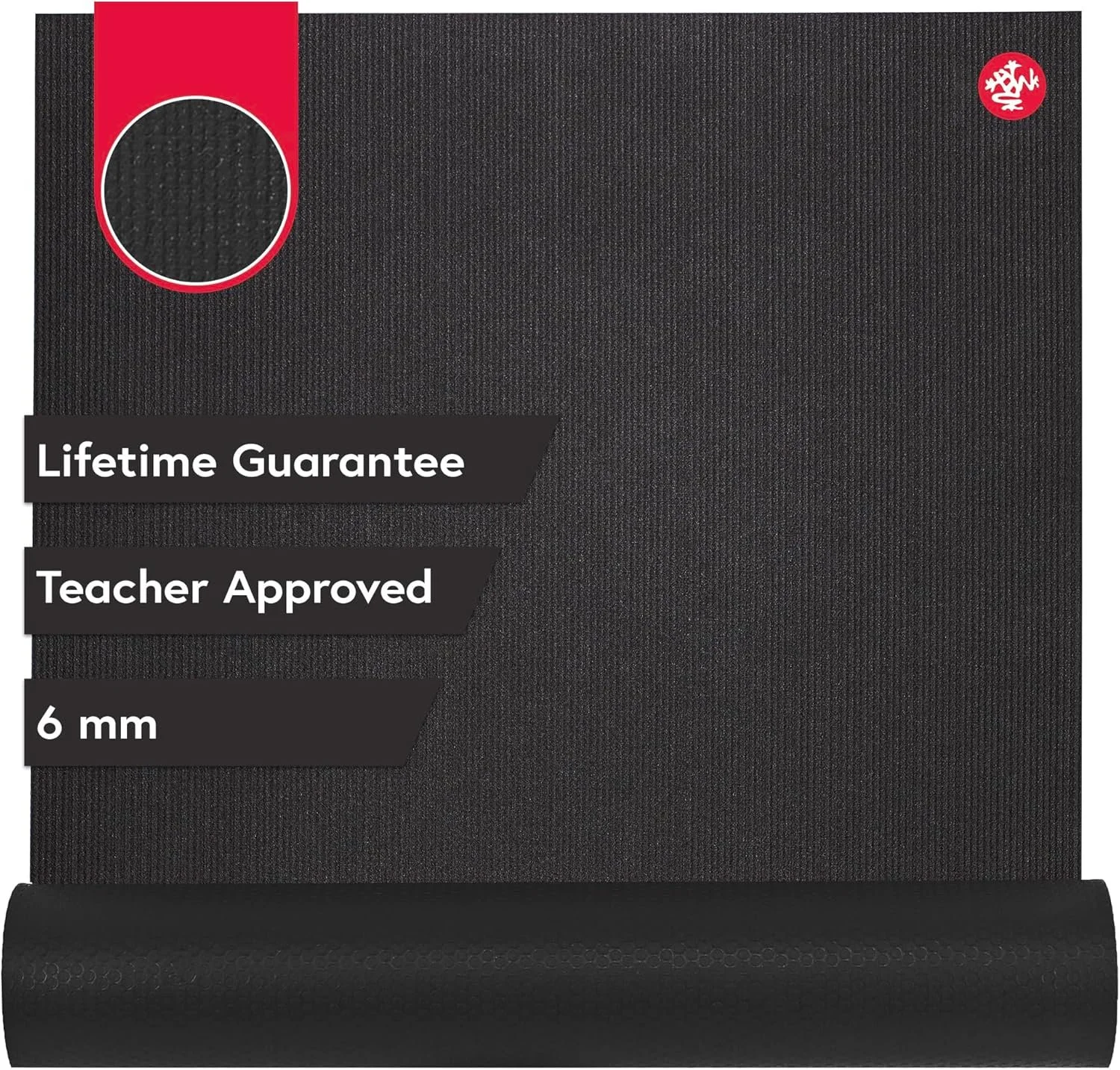 A black Manduka PRO yoga mat laid out on a floor for home workouts.