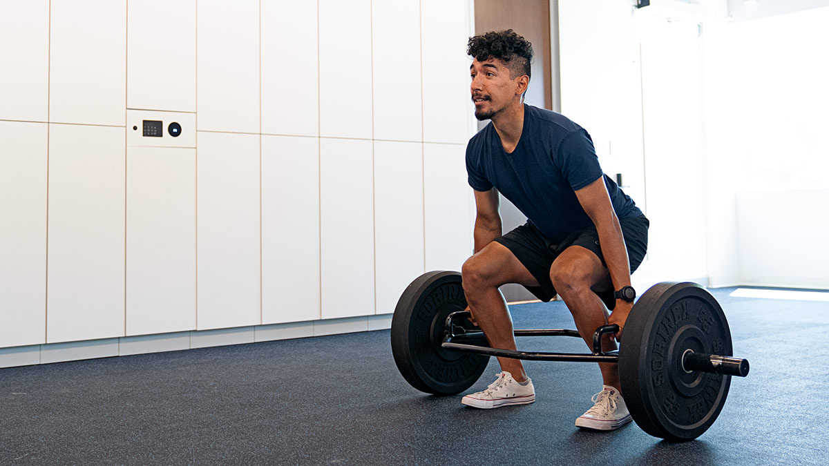 A man performing a barbell back squat with proper form.