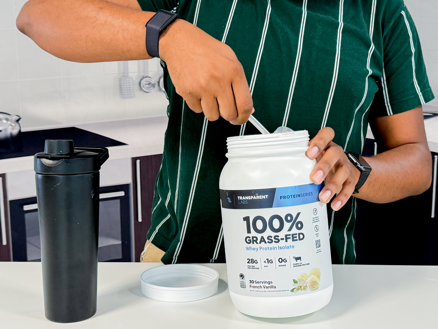 A person holding a bag of Transparent Labs protein powder showing its minimalist design.