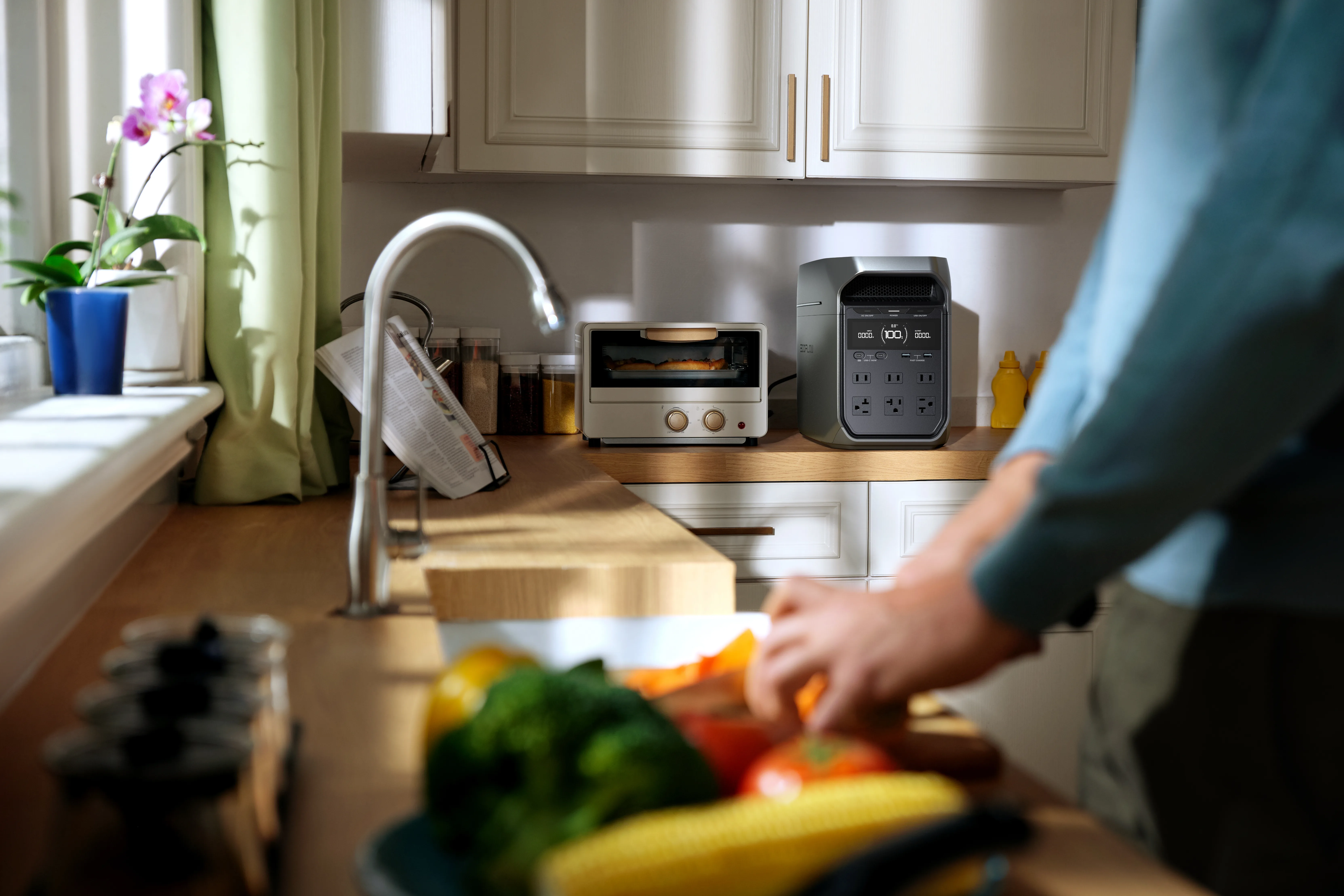 An EcoFlow DELTA 3 Plus power station sitting on a kitchen counter next to a toaster oven.