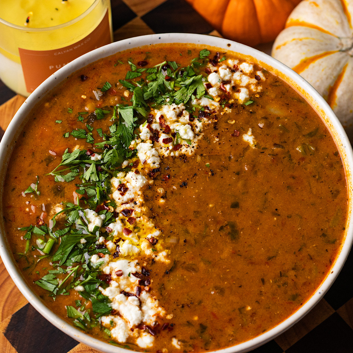 A top-down view of a nourishing plant-based lentil stew in a ceramic bowl.