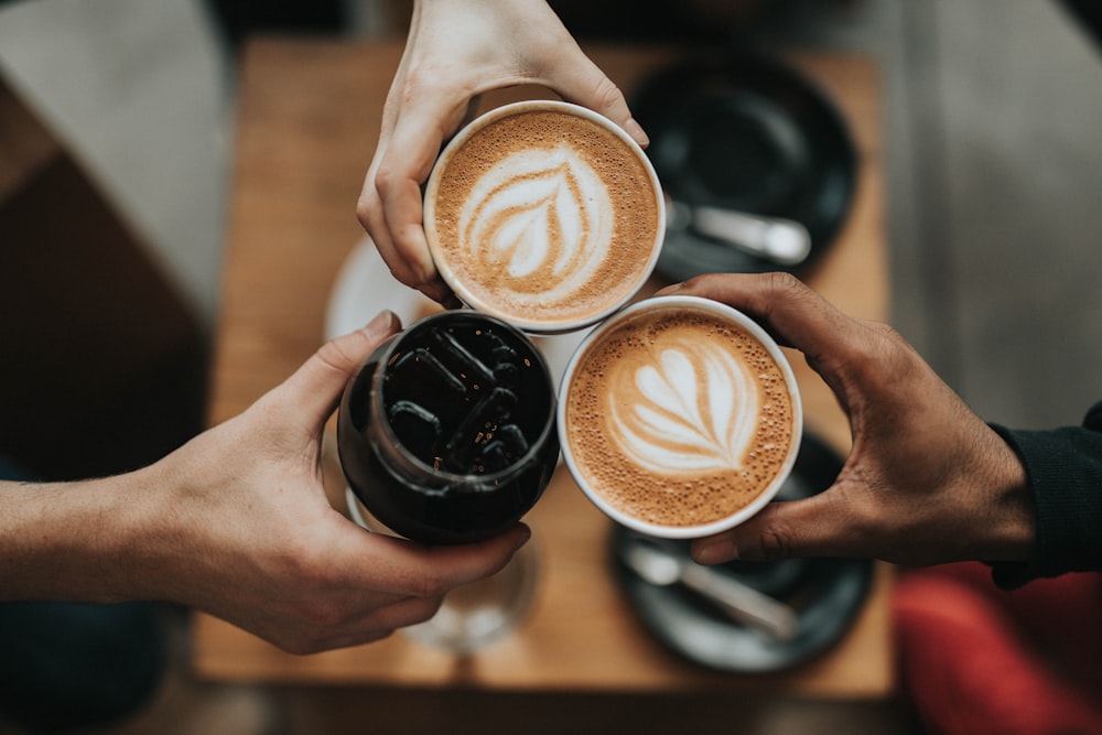 A cup of coffee on a table representing afternoon caffeine intake.