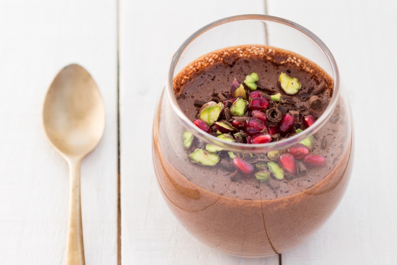 A side-angle view of chocolate mousse in a glass, clearly showing the light, bubbly, and aerated texture.