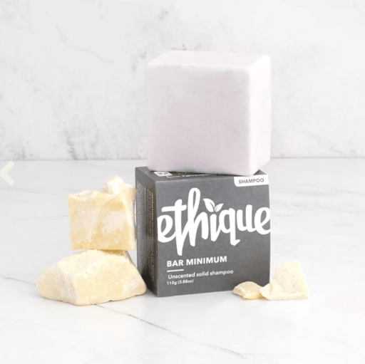 An eco-friendly solid soap bar on a wooden surface.
