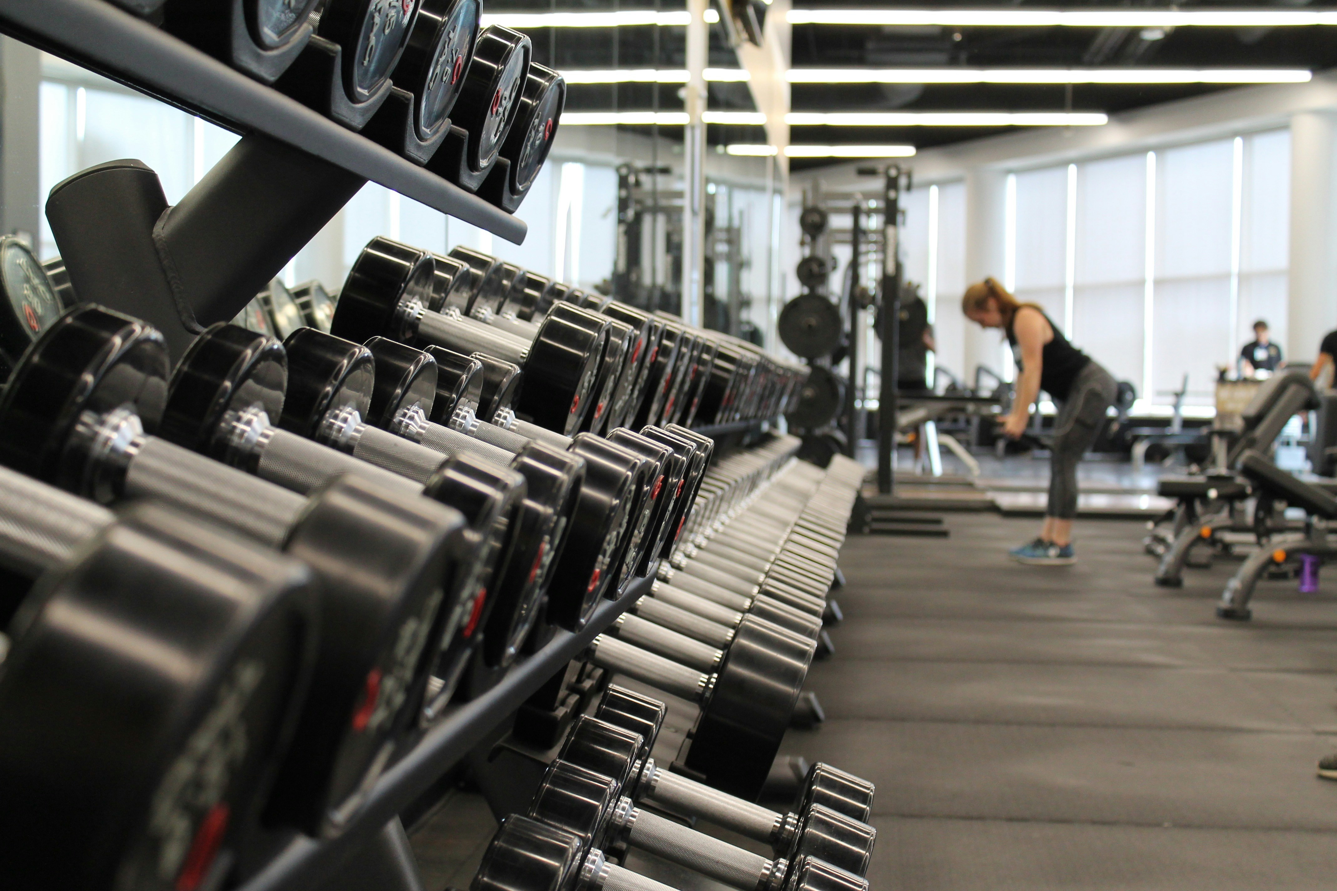 An athlete performing a controlled strength movement in a modern gym.