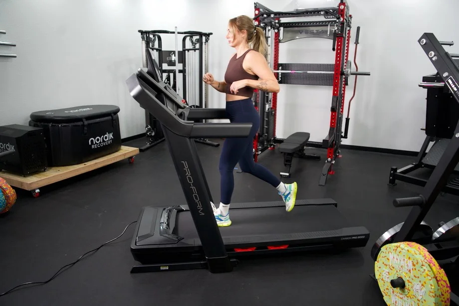 A person running at high speed on a ProForm Carbon Pro 2000 treadmill.
