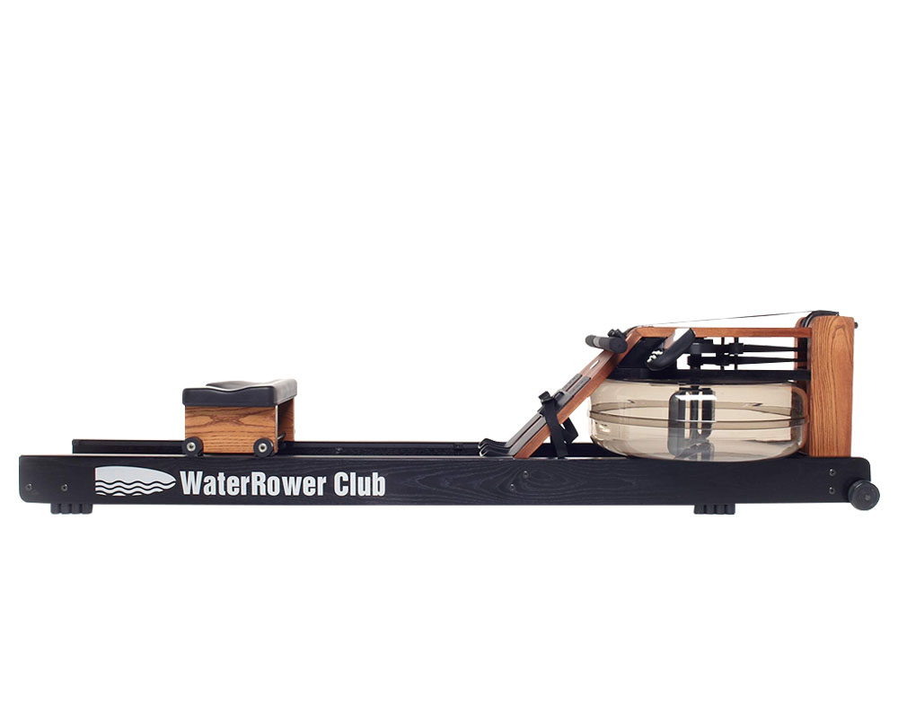 A WaterRower standing vertically against a wall to demonstrate its small storage footprint.