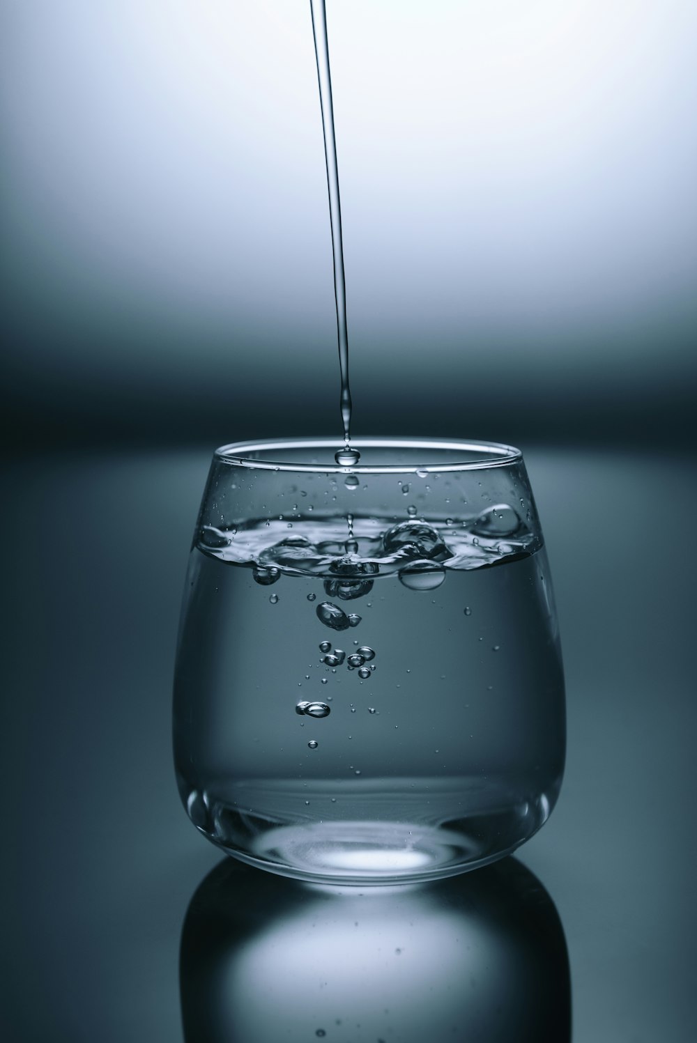 A fresh glass of sparkling water on a clean surface.