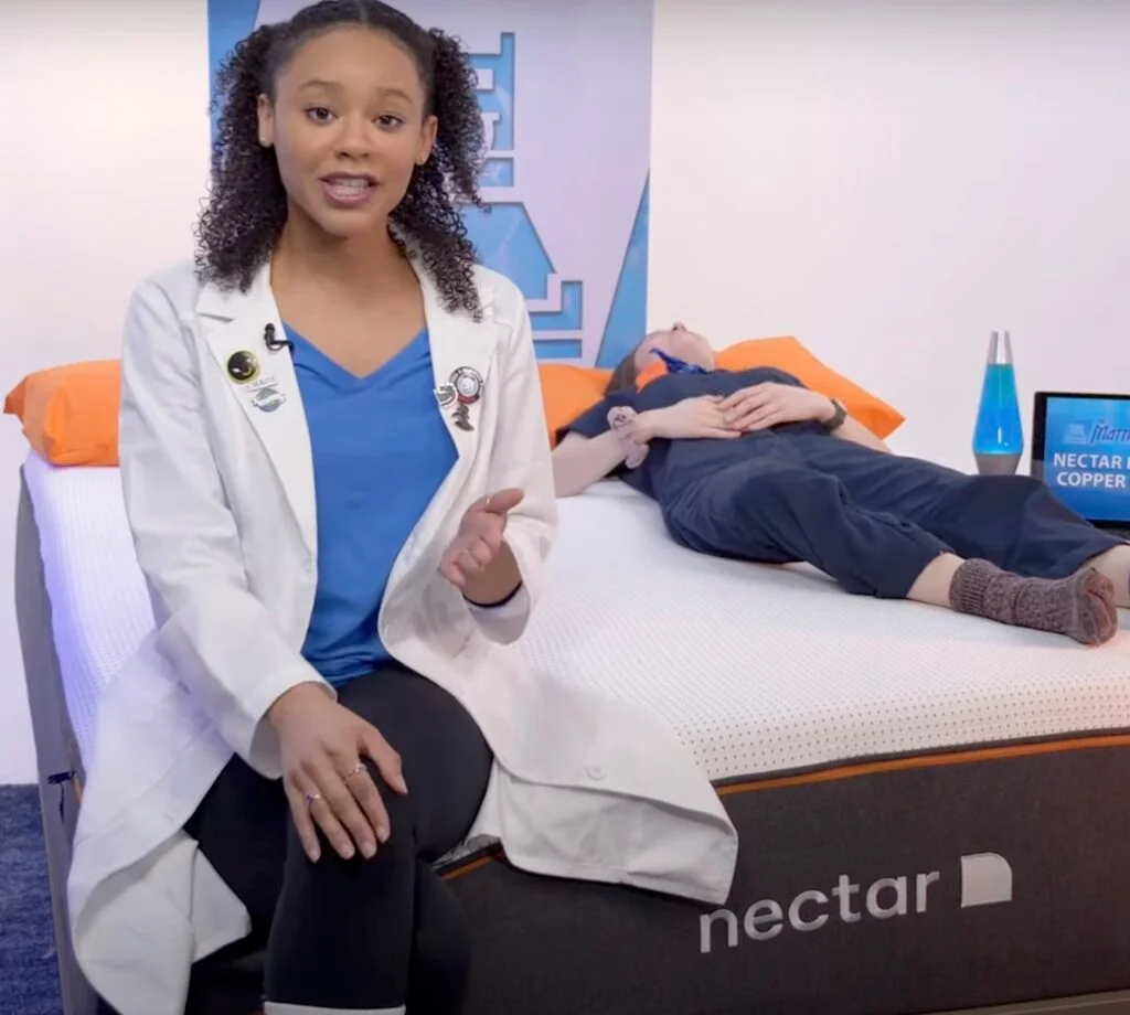 A person lying on their back on a mattress showing proper spinal alignment.