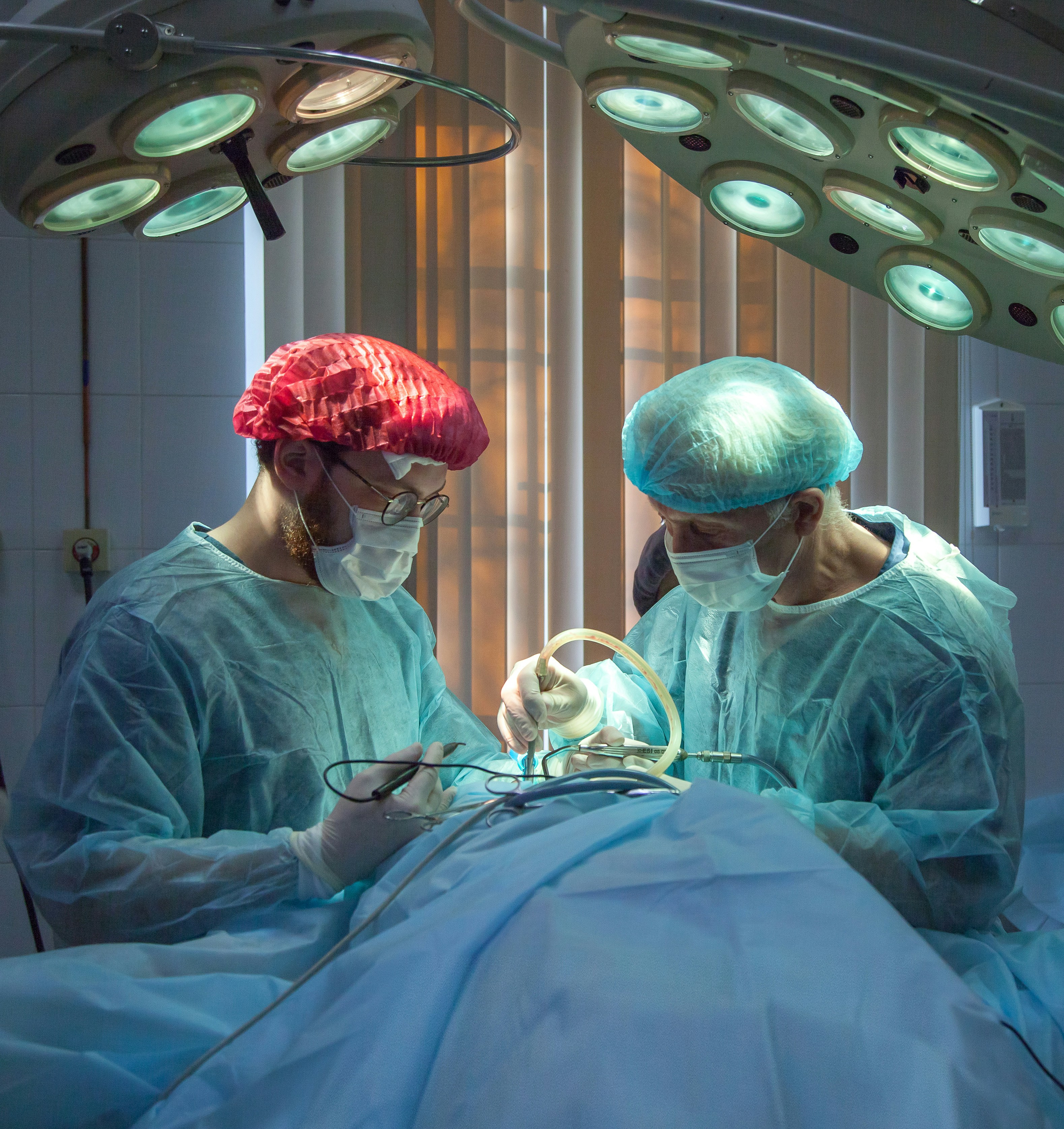 A healthcare professional talking to a patient during a consultation in a brightly lit medical office.