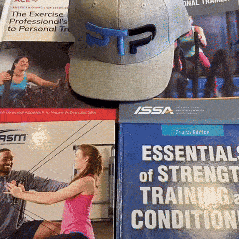 A person opening a National Academy of Sports Medicine (NASM) textbook to the chapter on heart rate zone training.