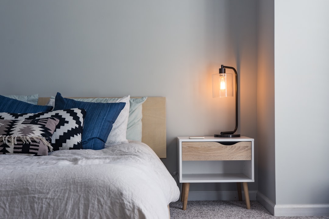 A clean, bright bedroom with high-quality white bedding and a comfortable mattress.