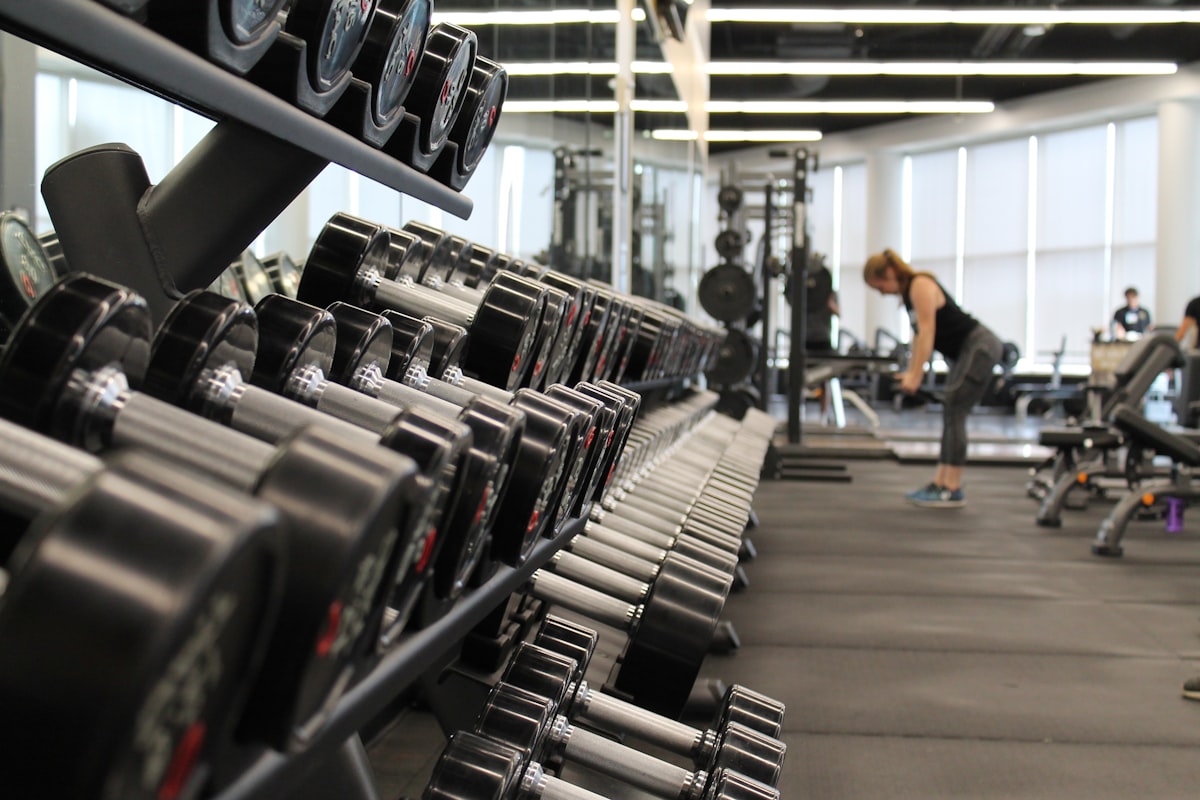 A user interacting with the Ergatta touchscreen display during a gamified workout session.