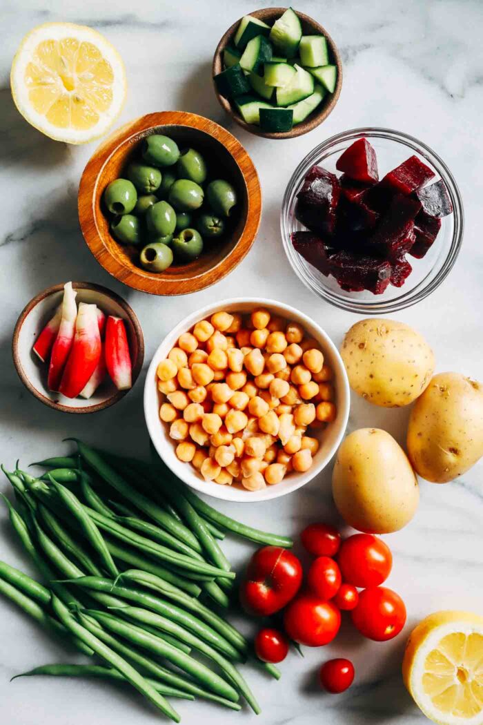 An overhead view of blanched green beans and red potatoes arranged on a plate.