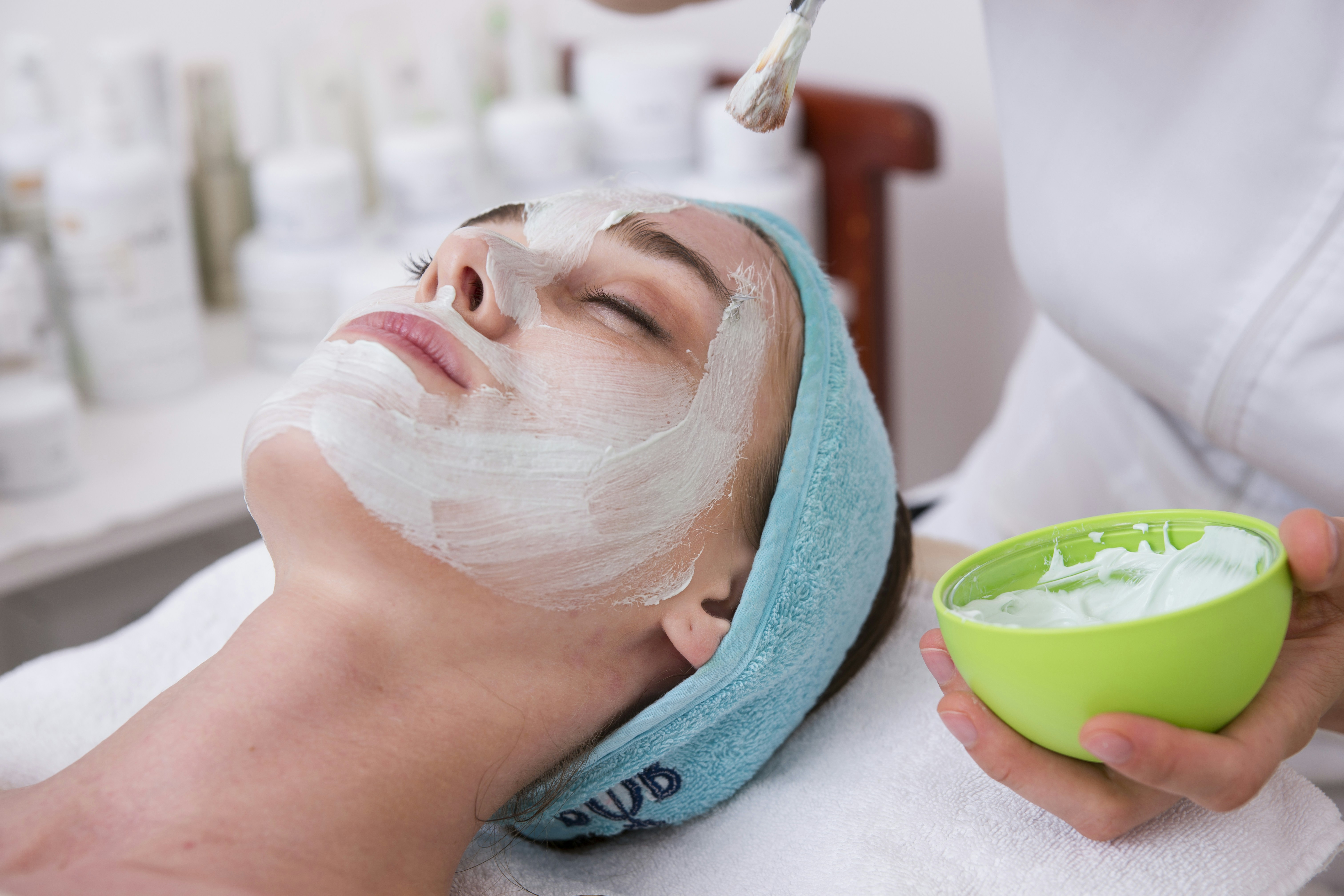 Skincare bottles labeled with active ingredients like retinol and chemical exfoliants.