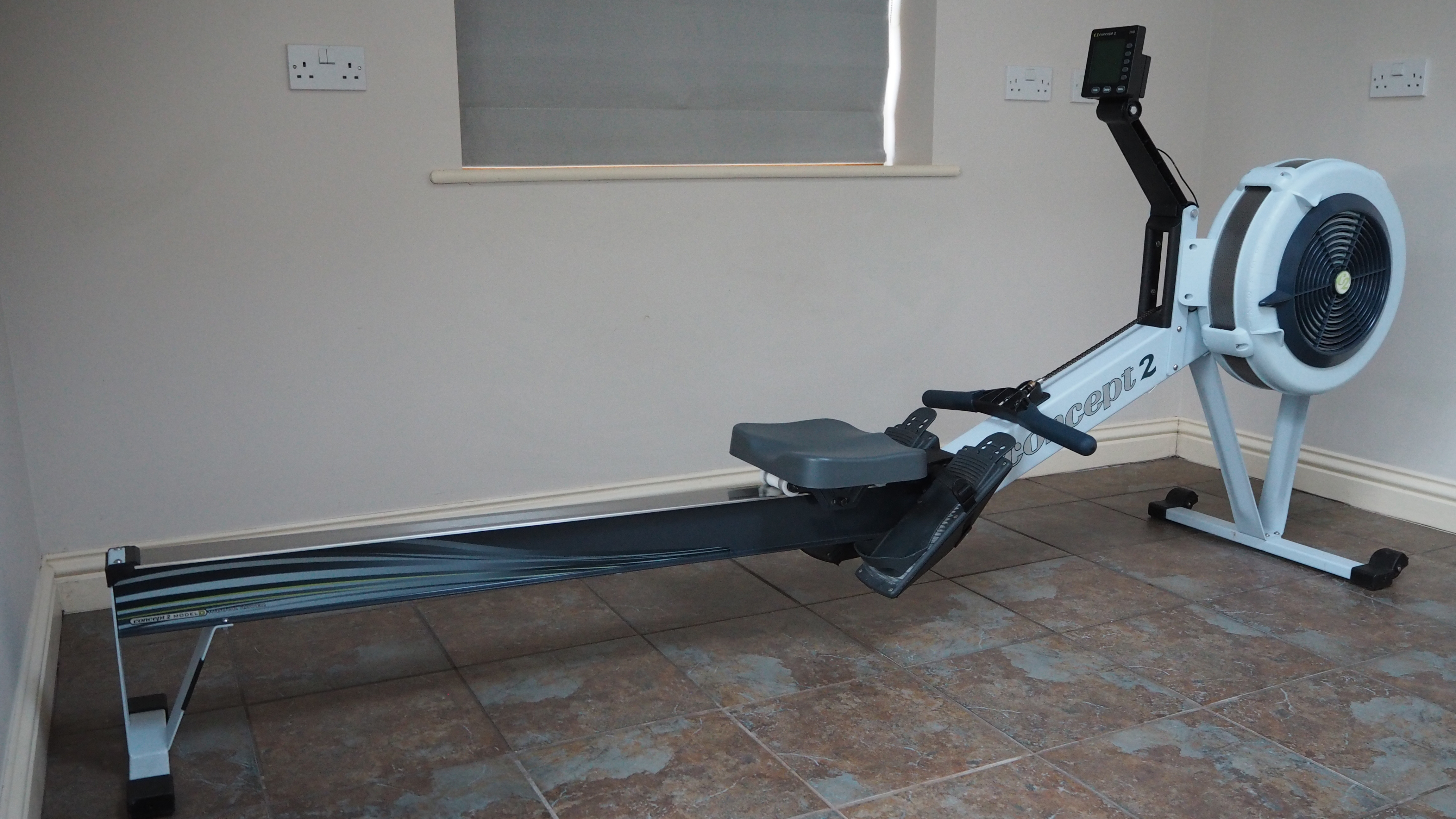 A black Concept2 RowErg air resistance rowing machine shown in a gym environment.