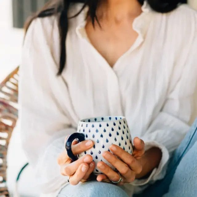 A handcrafted ceramic tea cup from Ten Thousand Villages.