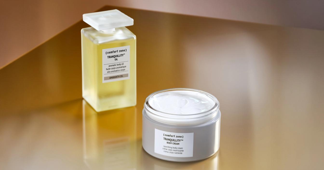 A soothing home spa setup with candles and wellness products on a wooden surface.