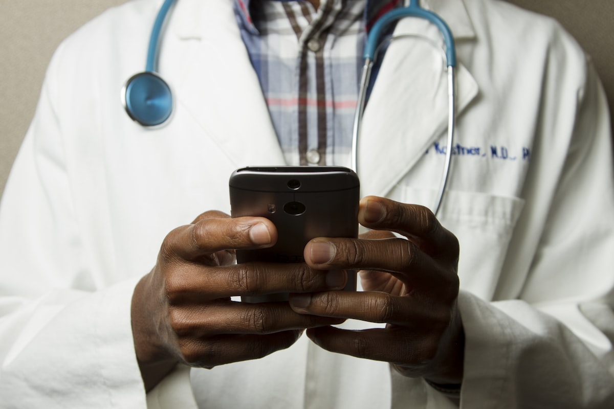 A person using a tablet to conduct a virtual medical consultation with a healthcare provider.